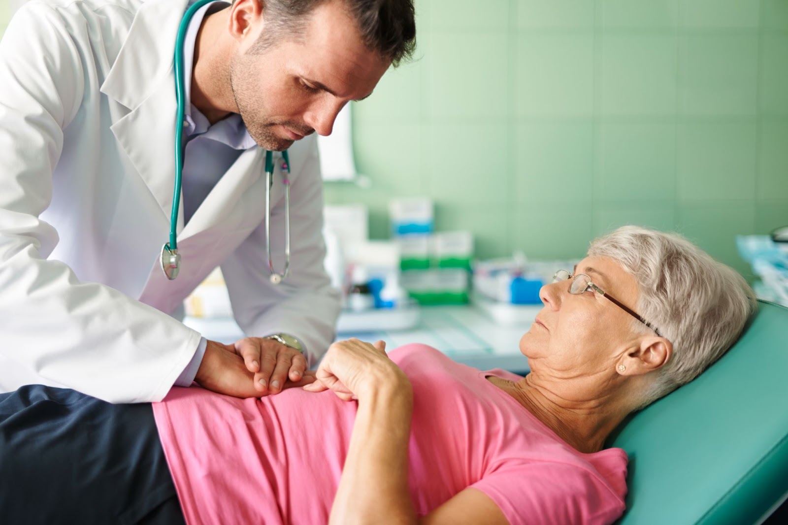 Male doctor check stomach of old patient