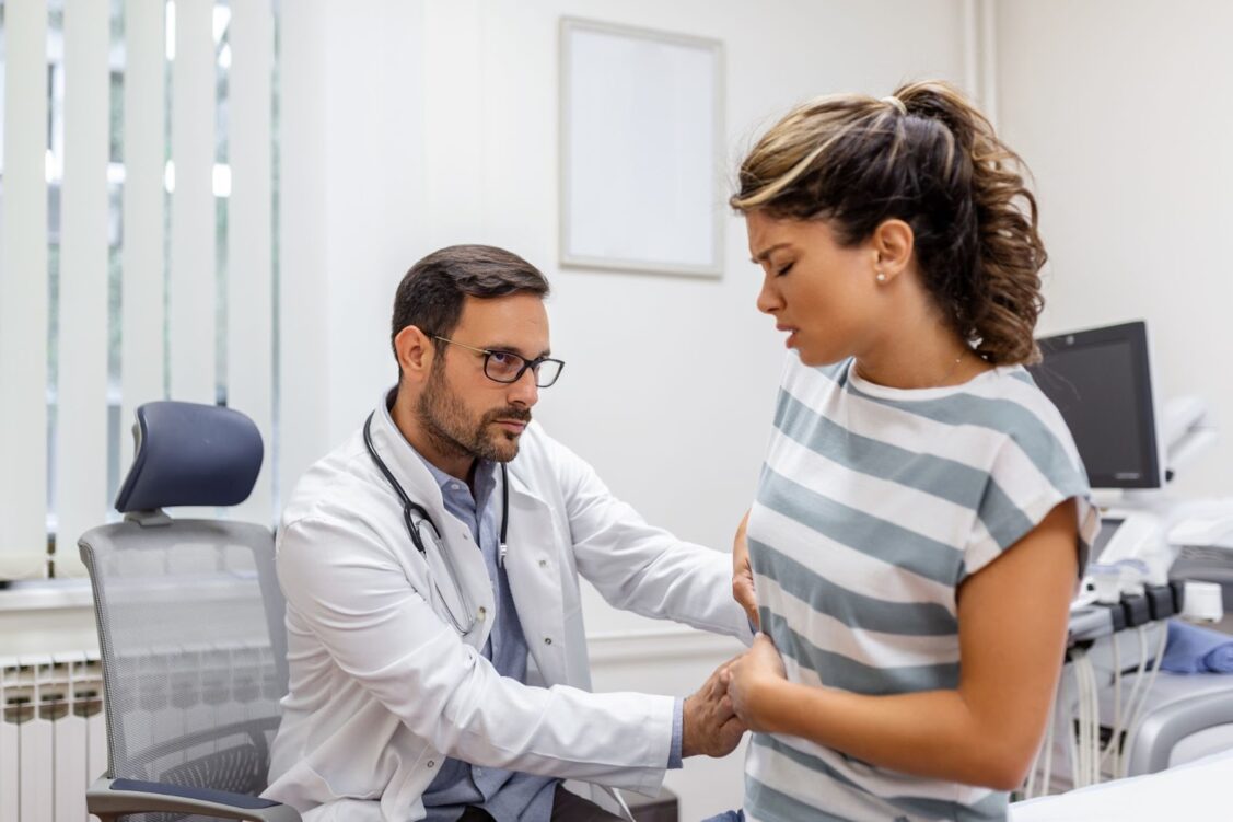 Male doctor check stomach of patient