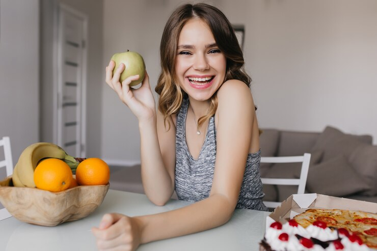 A Girl Smiling and Enjoying Fruits