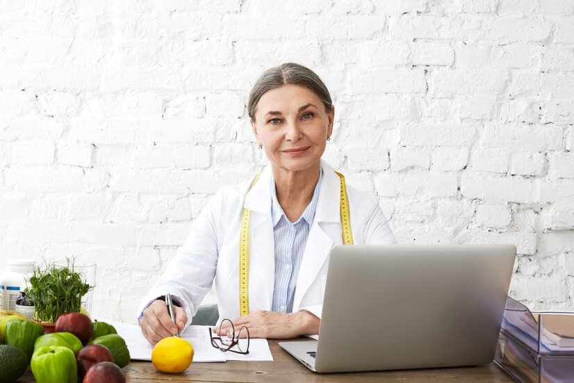 Doctor Sitting near the Laptop